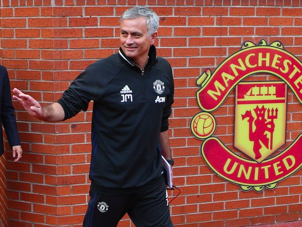 Manchester United's Portuguese manager, Jose Mourinho smiles and waves to fans